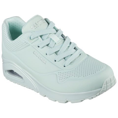 A mint green sneaker features a smooth surface with perforations and laces. It is designed for comfort and support, likely displayed on a neutral background.