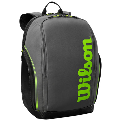 A gray backpack is displayed featuring bright green branding and zippers with a modern design showcasing multiple compartments and a sturdy build ideal for carrying sports equipment or everyday items.