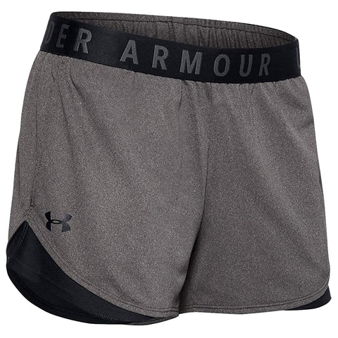Gray athletic shorts are displayed with a black waistband featuring the text UNDER ARMOUR. The shorts have a loose fit and a lower black panel at the hem.