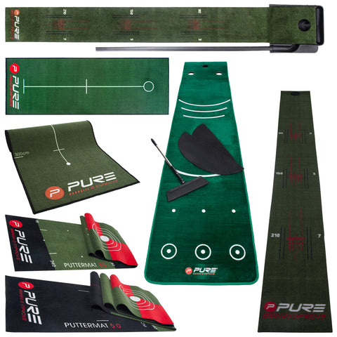 Various putting mats and accessories are displayed including aligning guides and practice tools designed for improving golf putting skills in a green indoor setting.