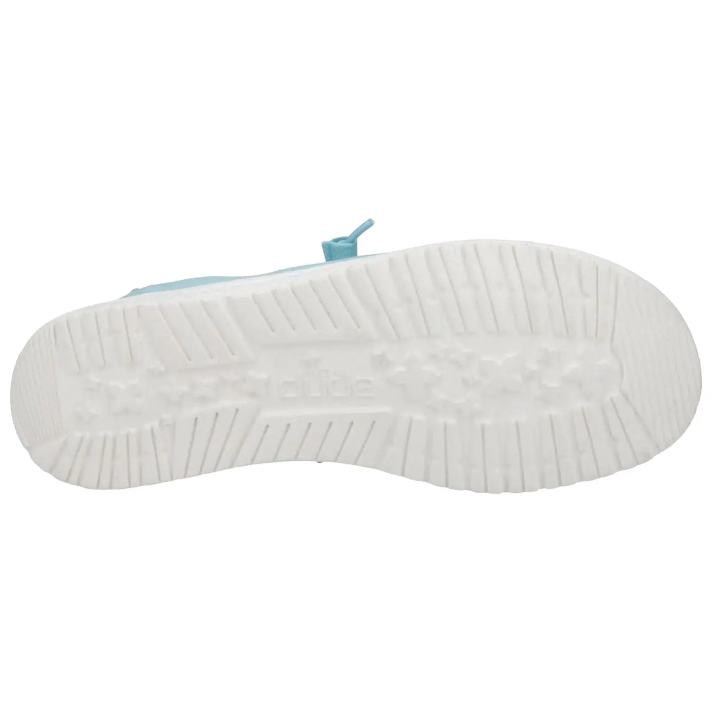 A light blue shoe sole is displayed showing tread patterns and a label while positioned on a flat surface providing a view of its design and texture.