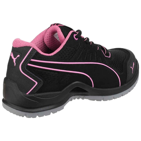 A black athletic shoe with pink accents is positioned at an angle showcasing its design and texture featuring laces and a padded collar in a neutral background.