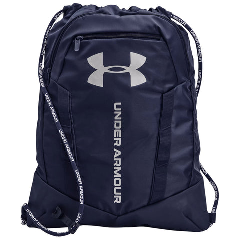 A navy blue backpack features a large silver Under Armour logo and the brand name printed vertically. It has a drawstring closure and adjustable straps for carrying.