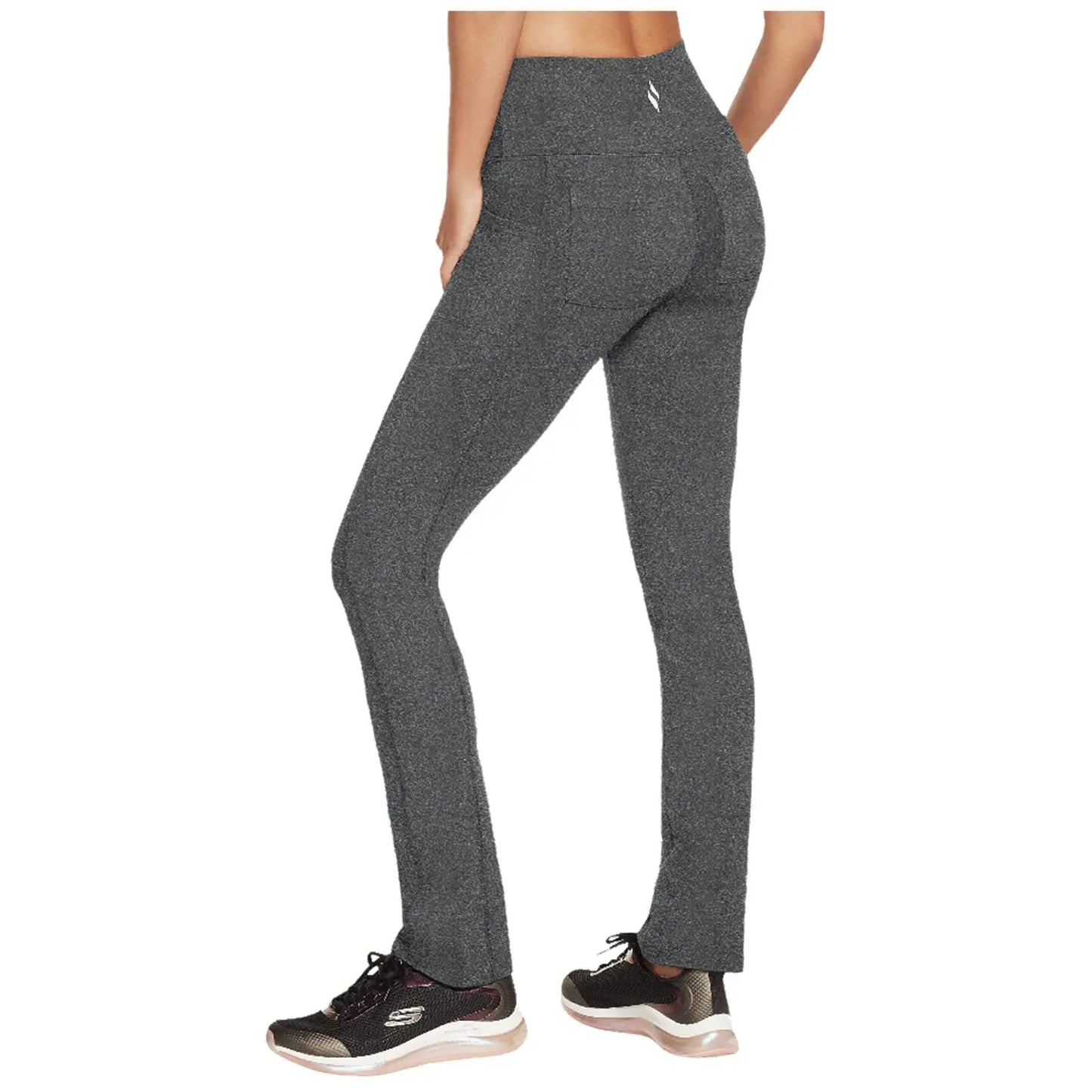 Leggings are being worn by a person facing away showcasing a high waistband and slim fit silhouette the setting suggests an active lifestyle with running shoes indicated