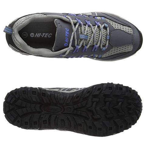 A grey and purple hiking shoe is displayed from above and below with visible laces and a textured black rubber sole suitable for outdoor terrain. The brand HI-TEC is visible inside the shoe.