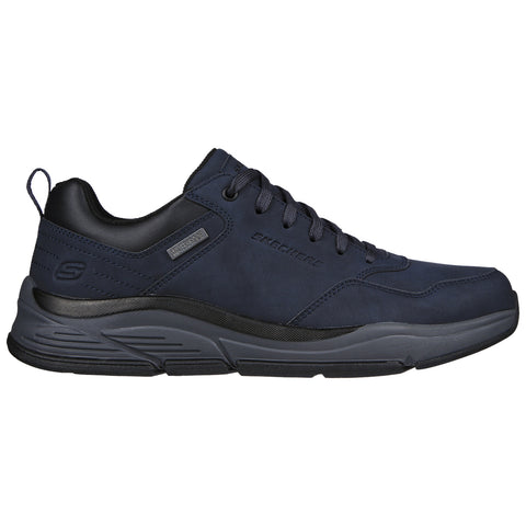 A navy blue sneaker is displayed resting on a flat surface with a sleek design featuring a cushioned sole and laces for fit, suitable for casual or athletic wear.
