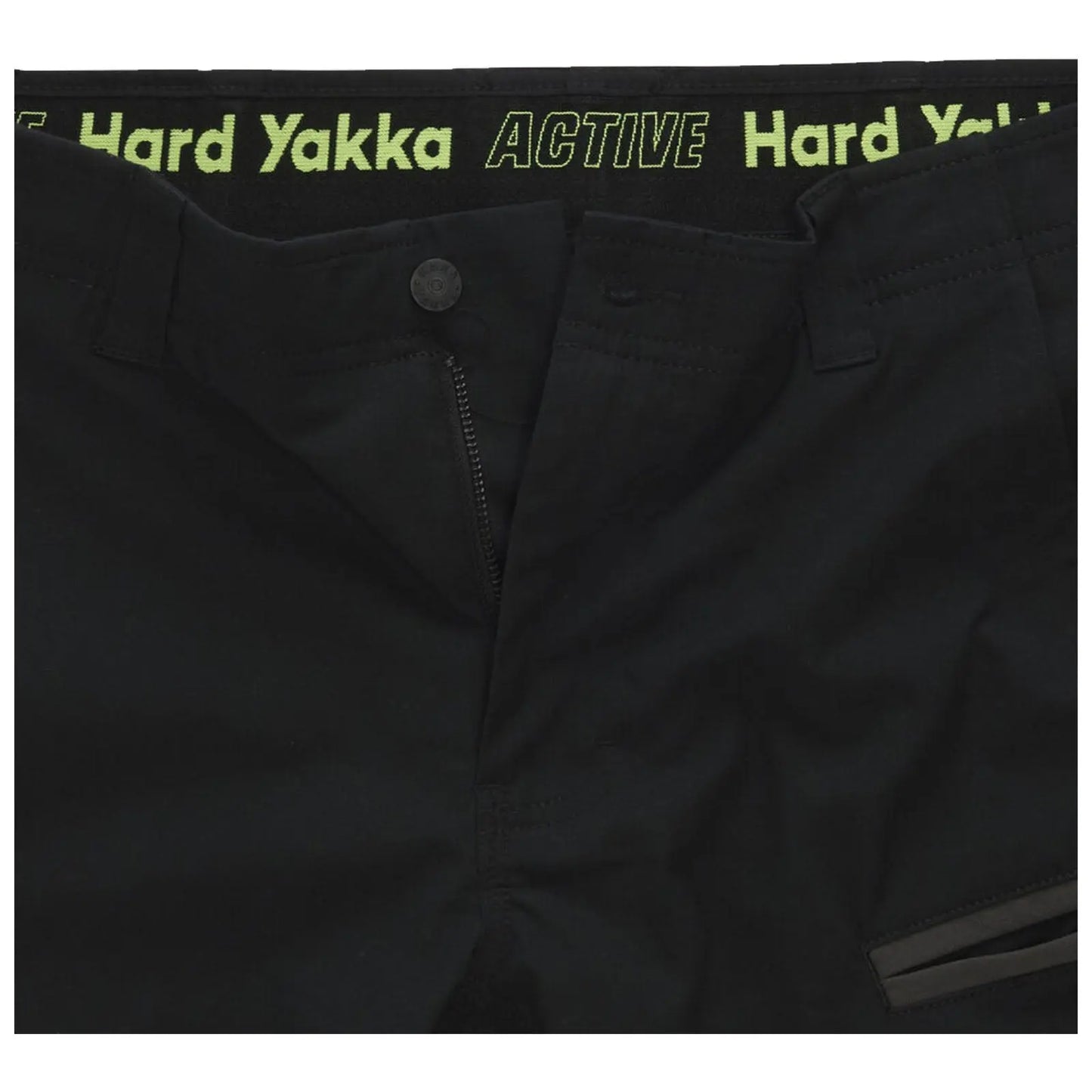 Black pants are displayed with a visible zipper and button closure featuring a waistband that has the text "ACTIVE Hard Yakka" in bright green writing along the top edge.