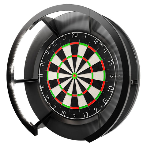 A circular dartboard features a black and white bullseye design with red and green segments while mounted in a black casing with lights illuminating the edges in a game room setting.