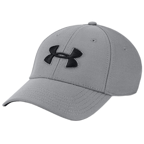 A gray baseball cap features a black Under Armour logo on the front while sitting at an angle against a plain background providing a clean visual focus on the hat.