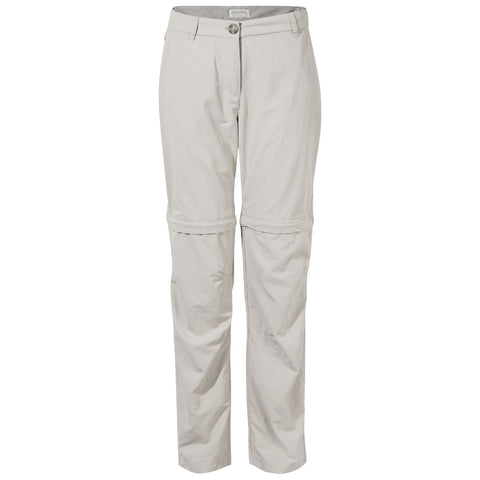 Light-colored zip-off pants hang vertically displaying two sections that can be unzipped into shorts they are made of lightweight fabric suitable for outdoor activities