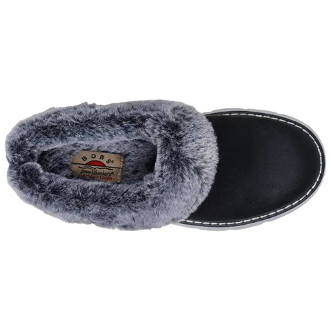 A black slipper with a soft gray faux fur lining is positioned upright showing its rounded toe and plush interior surrounded by a plain white background.
