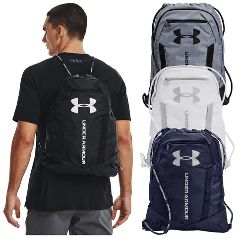 A man wearing a black shirt is shown from behind carrying a black Under Armour backpack. Three additional backpacks in gray, white, and navy are displayed next to him.