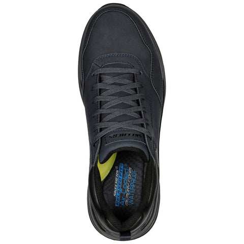 A dark gray athletic shoe is displayed with laces pulled tight it features a waterproof label inside the shoe emphasizing comfort and durability in various conditions.