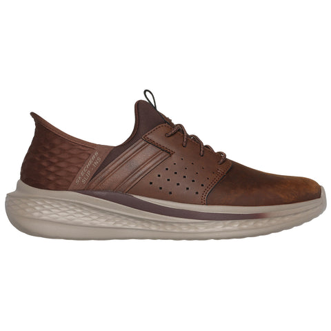 A brown sneaker features a smooth leather upper with perforations and a textured heel. It is displayed on a plain background, emphasizing its modern design and lightweight sole.