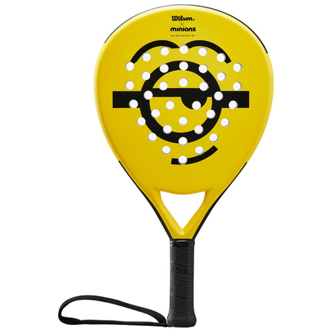 A bright yellow padel racket features a dotted and striped design. It's gripped firmly, ready for play on a court, showcasing a playful Minions theme.