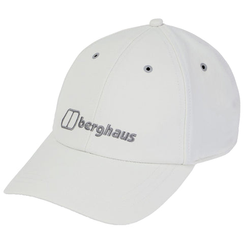 A white cap rests on a flat surface displaying the brand name berghaus in grey embroidery with a curved brim and ventilation holes on the sides.