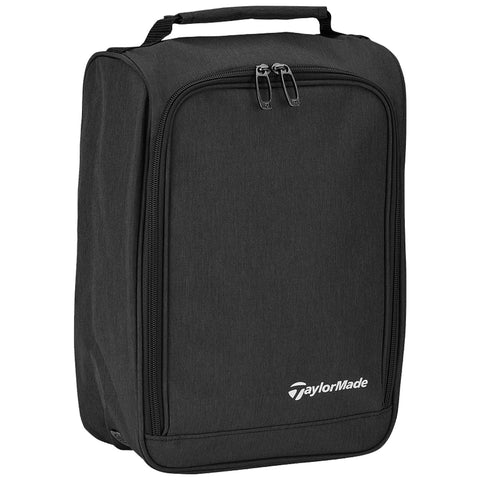 TaylorMade Performance Shoe Bag N8947901 A black rectangular golf bag with a handle and zippers is displayed against a plain background showcasing the TaylorMade logo on the front. It is designed for transporting golf equipment.