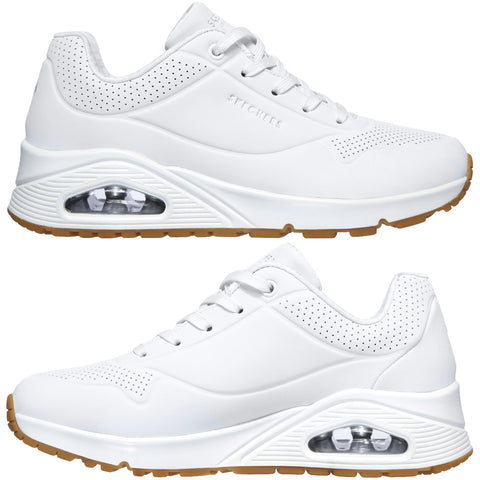 White sneakers feature a perforated design and a visible air-cushioning unit in the sole with a gum rubber outsole providing traction ideal for casual wear or exercise.