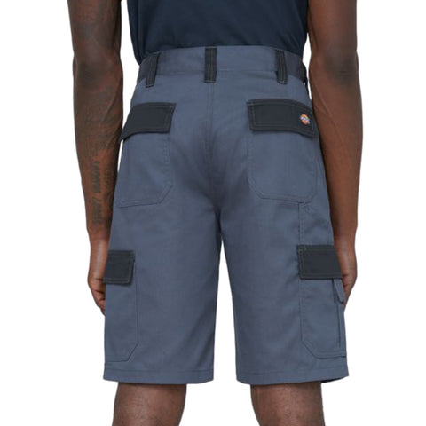 Gray cargo shorts are worn by an individual facing away from the viewer with visible pockets on the sides the setting appears to be casual or outdoor.