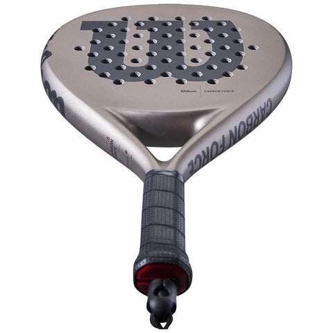 A paddle with a round face features numerous holes for improved playability and a textured grip handle. It is designed for sport use and showcases a sleek metallic finish.