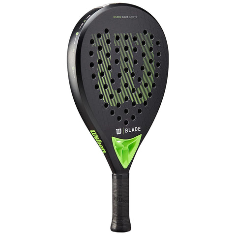 A black paddle with a teardrop shape features a textured surface and large holes for ball control branded as Wilson Blade Elite TX with a green accent and a rubber grip.