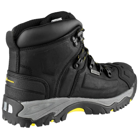A black hiking boot features a rugged design with yellow accents and metal eyelets for laces positioned on a gray sole, designed for durability in outdoor settings.