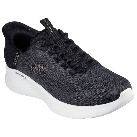 A black athletic shoe with a textured upper and white sole is displayed from an angled position showcasing its laces and branding emphasizing comfort and style for active wear.