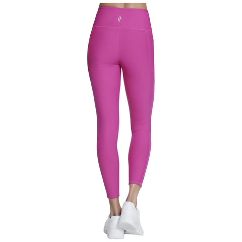 Fitted pink leggings are displayed standing upright against a plain background showcasing a simple athletic style ideal for workouts or casual wear with white sneakers completing the look.
