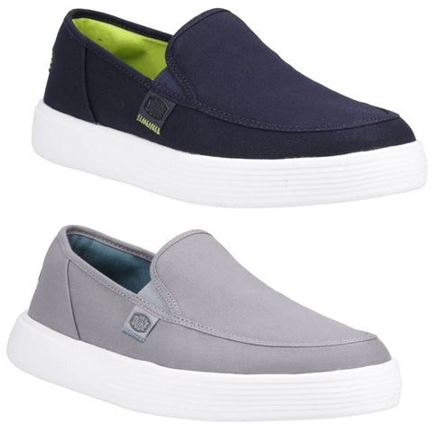 Two slip-on shoes are displayed one navy blue on top and one light gray below both have white rubber soles the interior of the navy shoe is bright green while the gray shoe has a blue interior