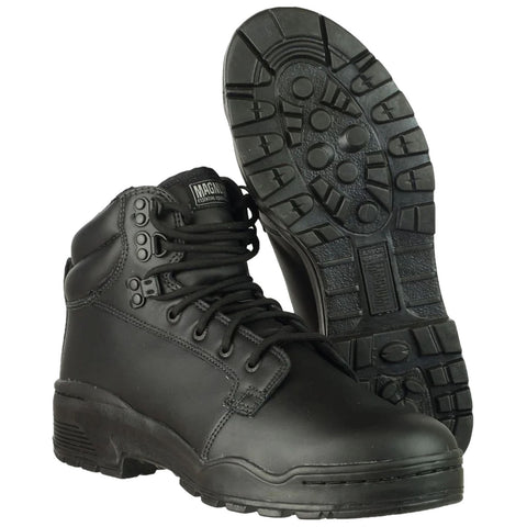 Black combat boots are positioned upright with laces tightened while the soles display a rugged tread pattern set against a plain white background emphasizing their sturdy construction and practical design.