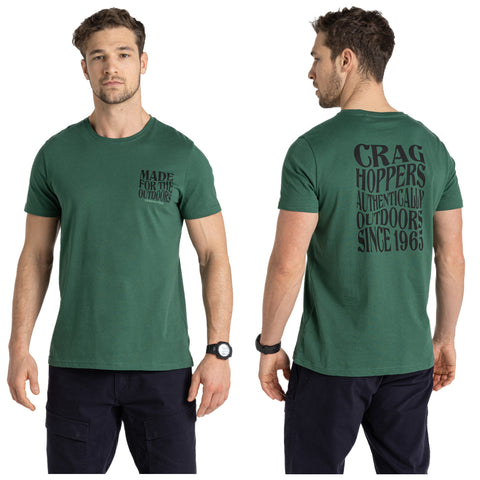 A man wearing a green t-shirt stands facing both front and back with arm relaxed displaying text on the shirt. The front text reads MADE FOR THE OUTDOORS and the back text reads CRAG HOPPERS AUTHENTICALLY OUTDOORS SINCE 1963. He also wears a watch on his left wrist.