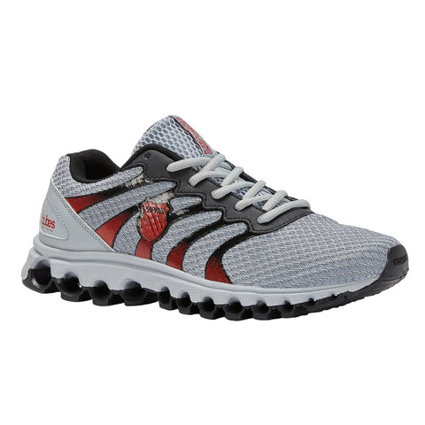 A gray and red athletic shoe rests on a flat surface featuring a mesh upper and a cushioned sole showcasing its lightweight design ideal for running or casual wear.