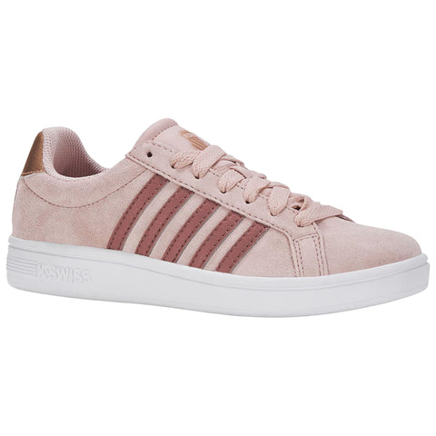 A pink suede sneaker with three brown stripes is positioned on a white surface showcasing its laces and low profile style suitable for casual wear.