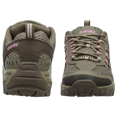 A pair of green hiking shoes is positioned with one shoe facing forward and the other backward showcasing the design details including mesh and pink laces in a neutral background.