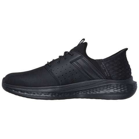 A black athletic shoe with a sleek design features a smooth surface and perforated detailing along the sides while showcasing a responsive sole on a clean white background.