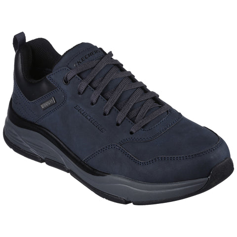 A dark blue sneaker is positioned upright showcasing its textured surface and lace-up design featuring Skechers branding while highlighting a sturdy sole suitable for walking or casual wear.