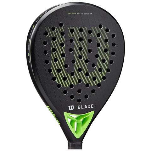 A black paddle with a perforated surface and green accents is displayed. It features the text "WILSON BLADE ELITE TX" and showcases a distinctive logo at the bottom.