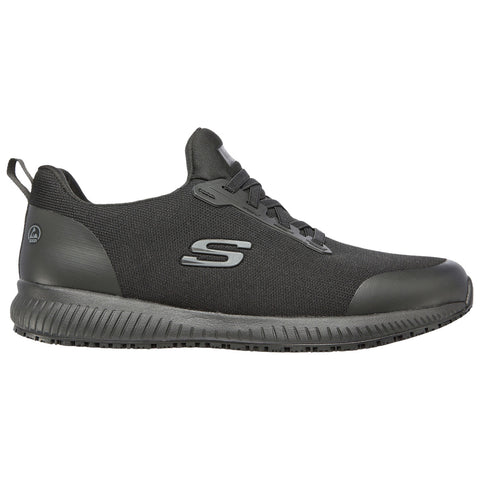 A black athletic shoe with a textured upper and a slightly raised sole is positioned sideways with laces tied showcasing a sleek and modern design suitable for sports or casual wear.