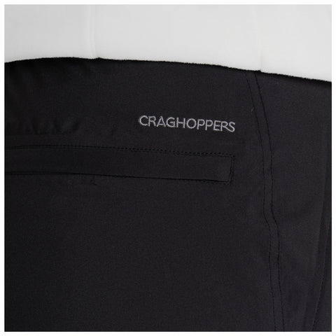 A black garment features a small pocket with the text CRAGHOPPERS embroidered above it, suggesting an outdoor or adventure context. The fabric appears smooth and durable.