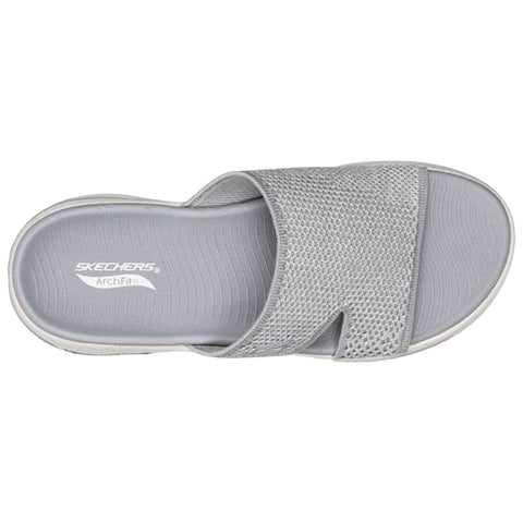 A grey slip-on sandal is displayed with a textured upper and an elastic band. It features comfortable cushioning and an ArchFit insole designed for support and comfort.
