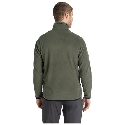 A person is wearing a green fleece jacket with a high collar and facing away from the viewer in a neutral background. The attire appears casual and suitable for outdoor activities.