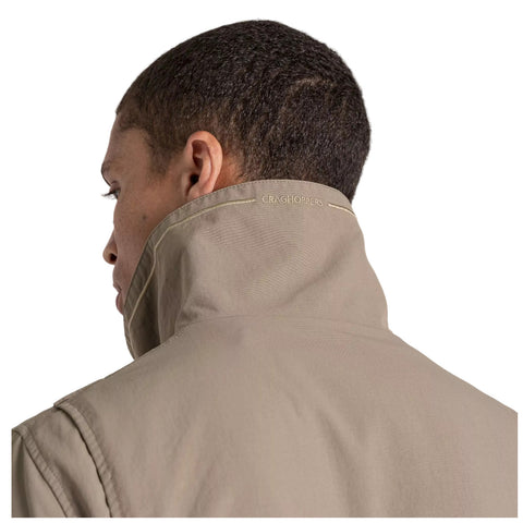 A person wearing a beige jacket stands with their back turned, showcasing the high collar. The brand name Craghoppers is subtly visible on the collar.