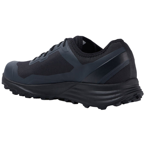 A black athletic shoe is positioned sideways showcasing its textured sole and sleek design emphasizing performance and durability suitable for outdoor activities in various terrains.