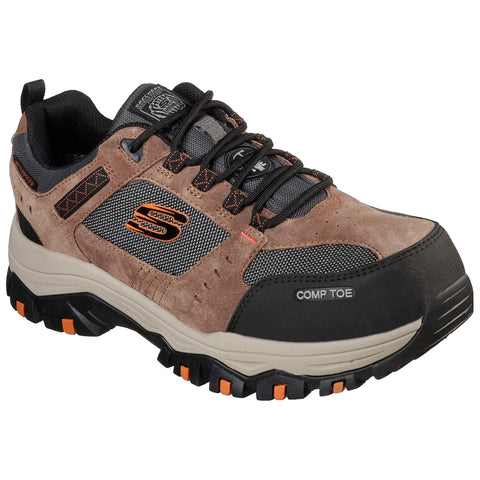 A brown and black safety sneaker with a composite toe and textured upper material sits on a flat surface showcasing its rugged design and laces while highlighting its cross-training style