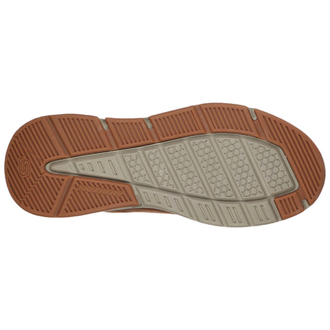 A shoe's sole is shown with a textured surface designed for traction featuring a combination of rubber and patterned sections indicating durability and grip on various surfaces.