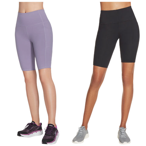Two pairs of fitted athletic shorts are displayed side by side. One pair is light purple while the other is black. Both styles are designed for active wear and feature a high waist.