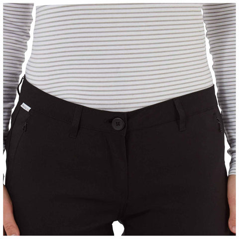 A person is wearing a fitted striped long-sleeve top and black pants featuring a button closure and side pockets against a plain background.