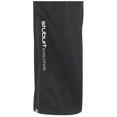 A black golf rain pant is displayed featuring a zippered pocket and the text "stuburt EVOLUTION" printed vertically in white on the side. The fabric appears smooth and functional for wet conditions.