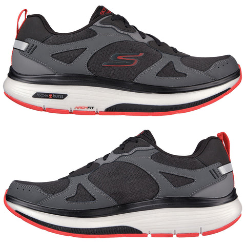 A black and gray athletic shoe with red accents rests against a white background featuring a mesh upper and cushioned sole designed for comfort and support during workouts. A pair of athletic shoes features a grey and black design with red accents. The shoes are positioned to showcase their mesh and synthetic material, ideal for comfort and support in physical activities.