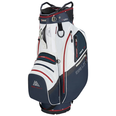 A golf bag stands upright featuring multiple pockets and a sleek white and navy design with red accents showcasing storage for clubs and equipment in an outdoor golfing context.